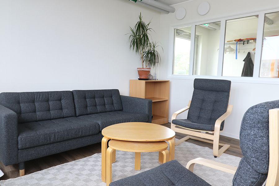 Rum med mörkgrå soffa och fåtöljer.