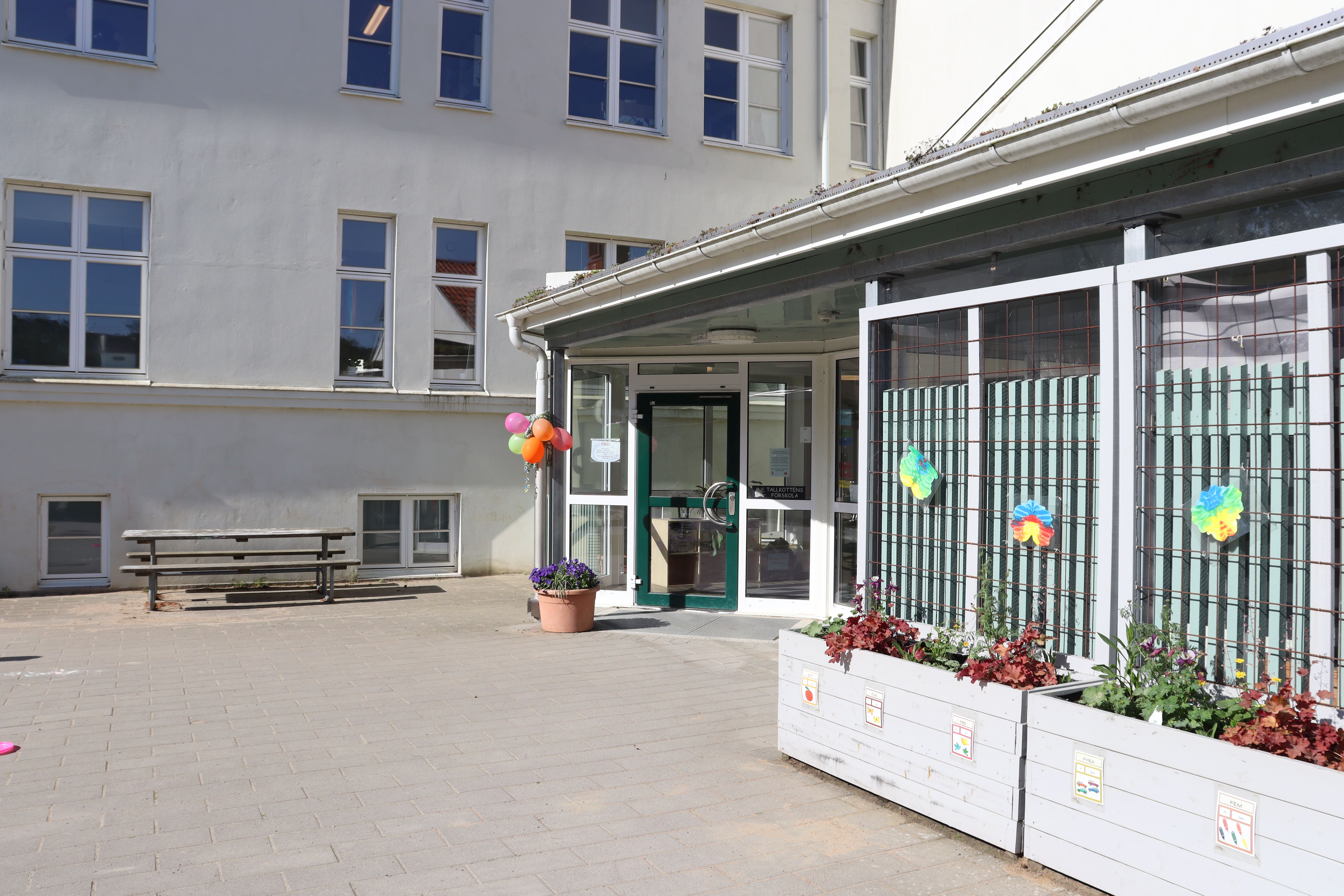 Vit byggnad utsmyckad med ballonger och pappersfjärilar