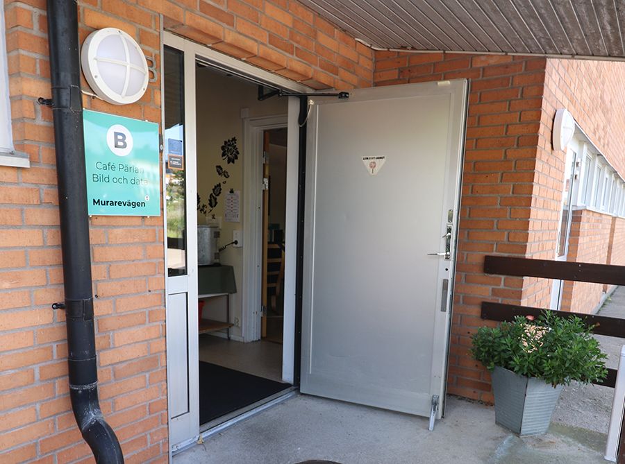 Entrén till ett orange tegelhus.